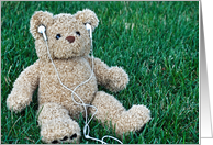 Birthday teddy bear on grass with ear phones card