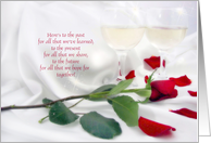 anniversary celebration with red rose and wine glasses on satin card